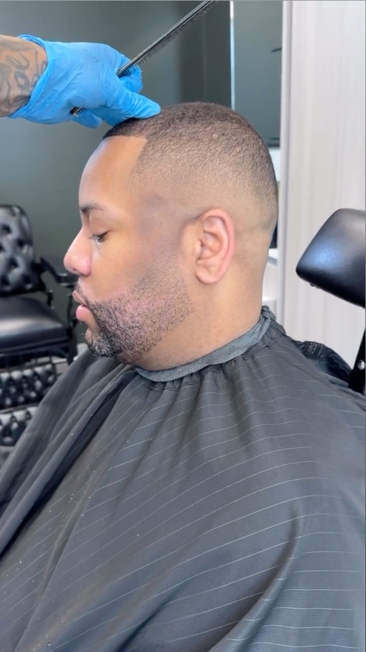 Close view of a haircut and beard line-up