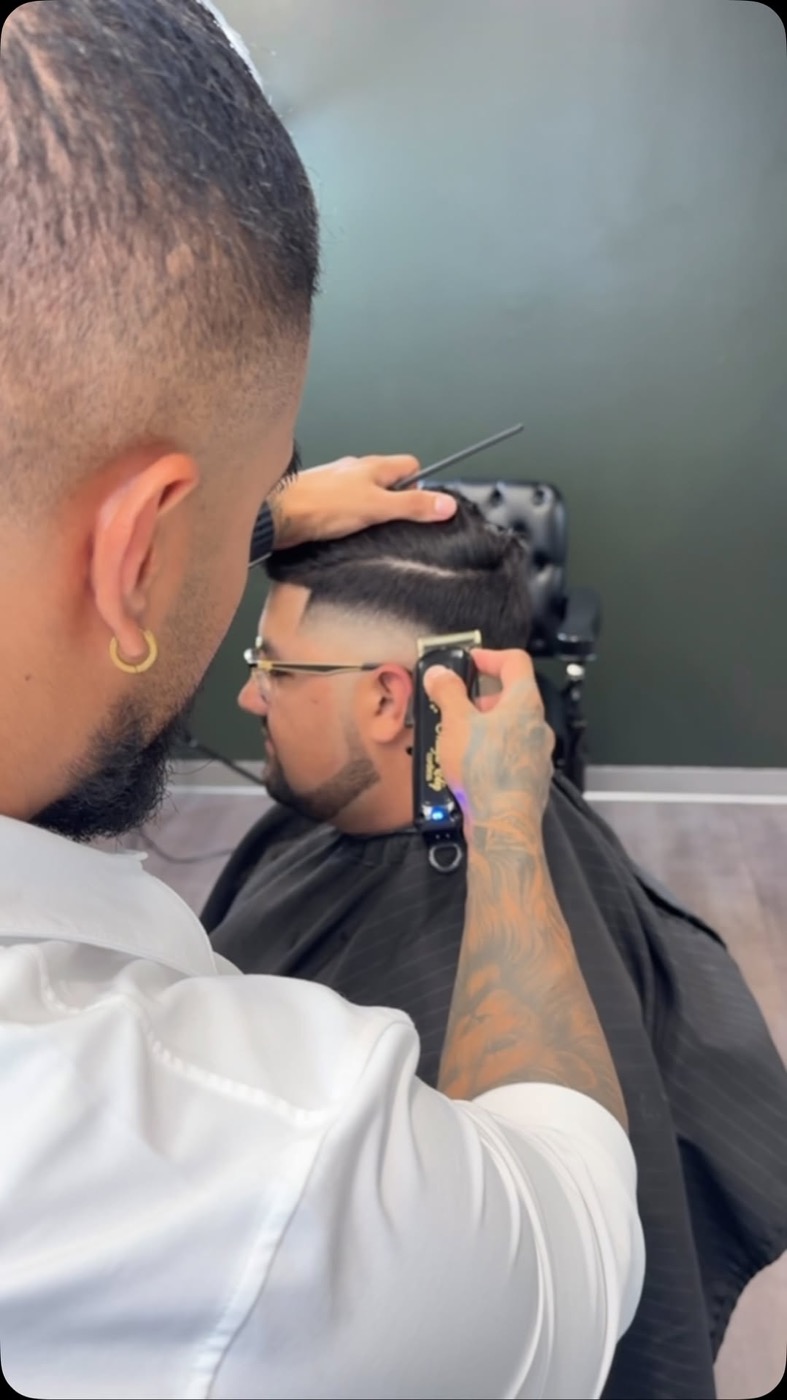 A barber working on a client's fade